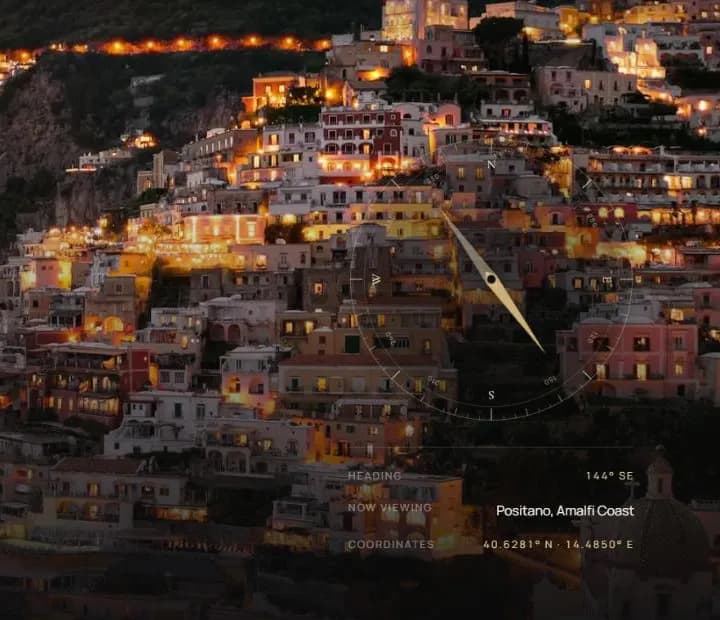 Positano at dusk with a gold compass needle and live heading readout.